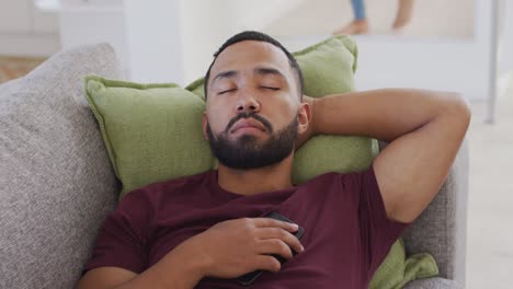 Man-sleeping-on-the-couch-at-home