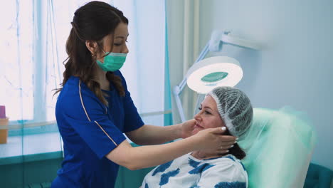 cosmetologist puts cap onto client head before procedure