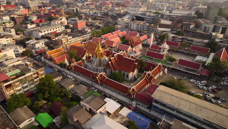 golden stupa temple in middle of bangkok metropolis at sunrise