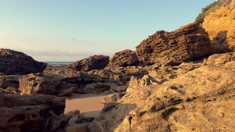 push in on rocky beach at sunrise, day