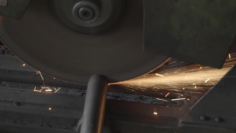 close up of steel cutting machine automatic and sparks while grinding iron in the industrial factory. slow motion