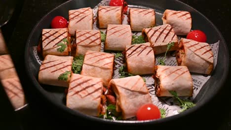 chicken shawarma pieces stuffed with barbecue sauce under a hot plate