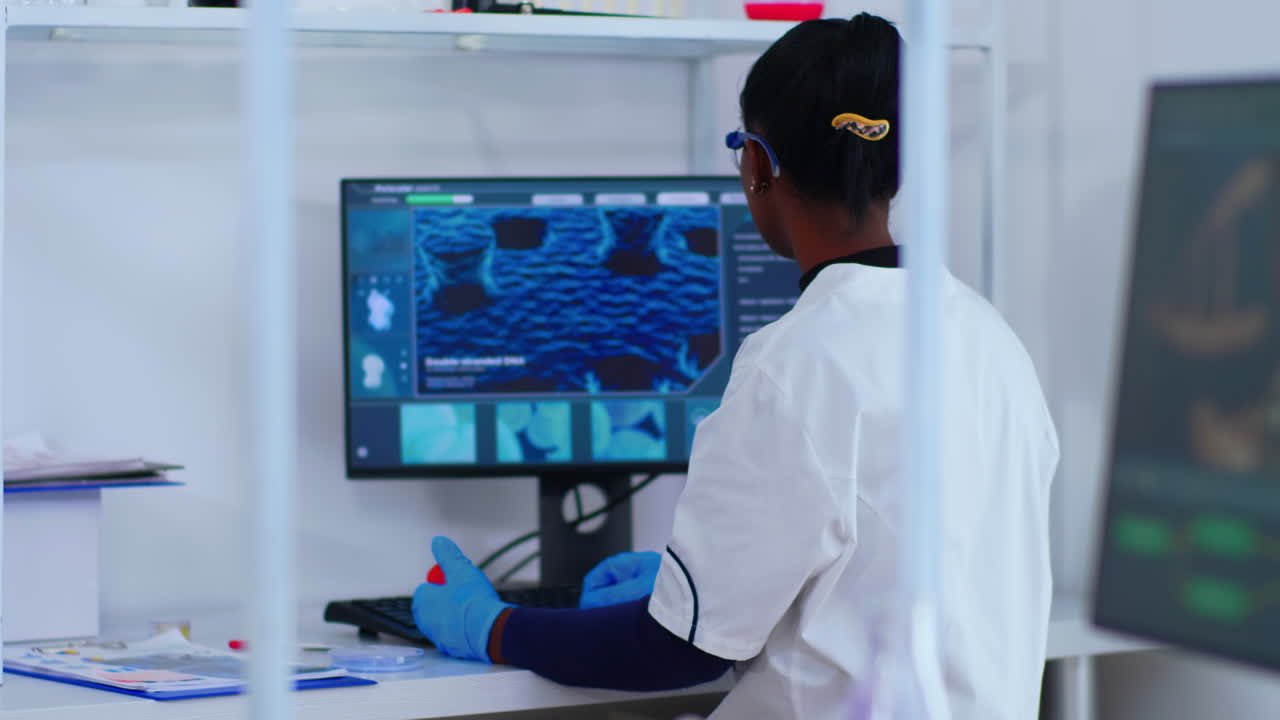 African chemist nurse writing on computer analysis results