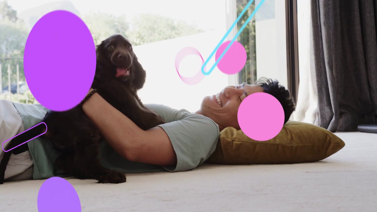 Man lying on carpet puppy entering licking petting cradling graphics over man promoting pet care