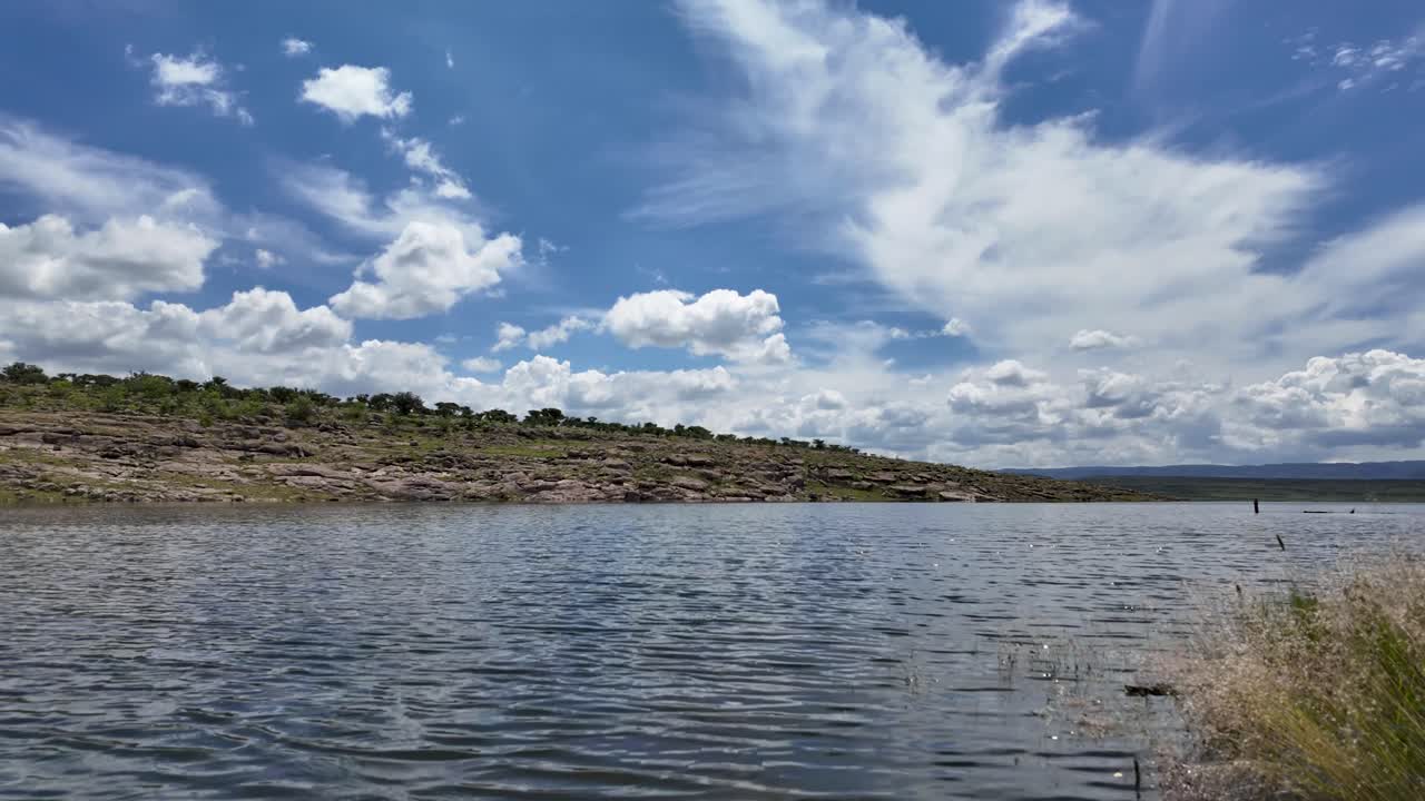 Hyperlapse shot along the shore of the Calles Dam, captured from the islet of the Broken Christ during a summer midday in the Magic Town of San José de Gracia, Aguascalientes, Mexico