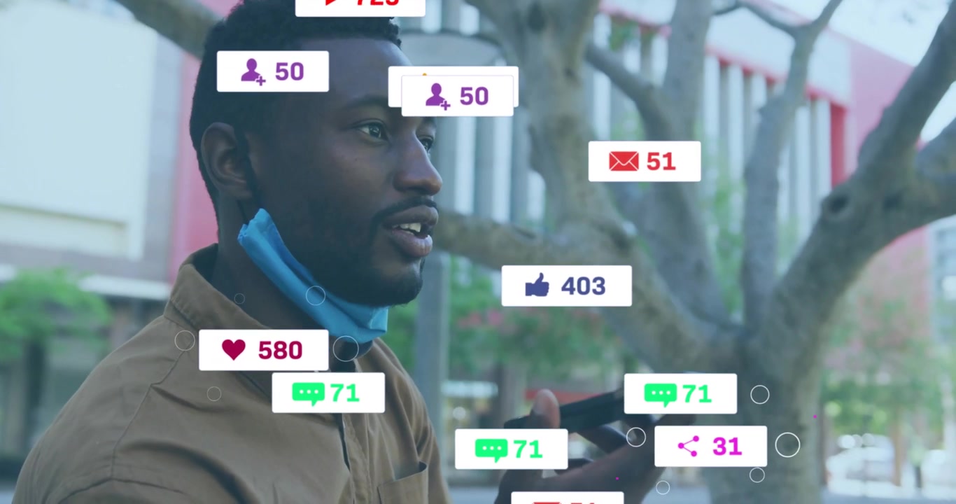 Man raising smartphone speaking while social media icons emerging around mask indicating engagement