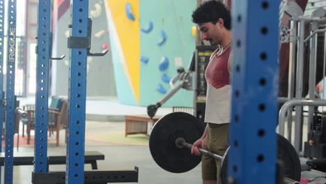 Barbell Bicep Curls - Man Lifting Barbell In The Gym. - wide shot