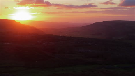 establishing drone shot of yorkshire dales into the sun at sunset uk