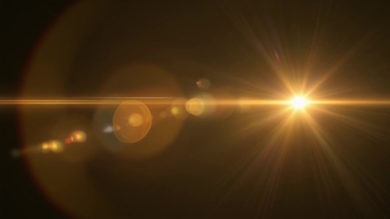 Effetto Flare Lente Dorato su Sfondo Scuro