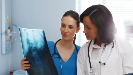 male and female doctor discussing over x-ray report