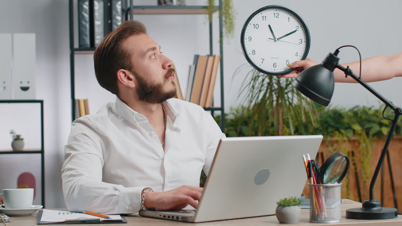 Young businessman with anxiety checking time on clock, running late to work being in delay deadline