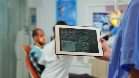 close up dentist nurse holding tablet with digital radiography