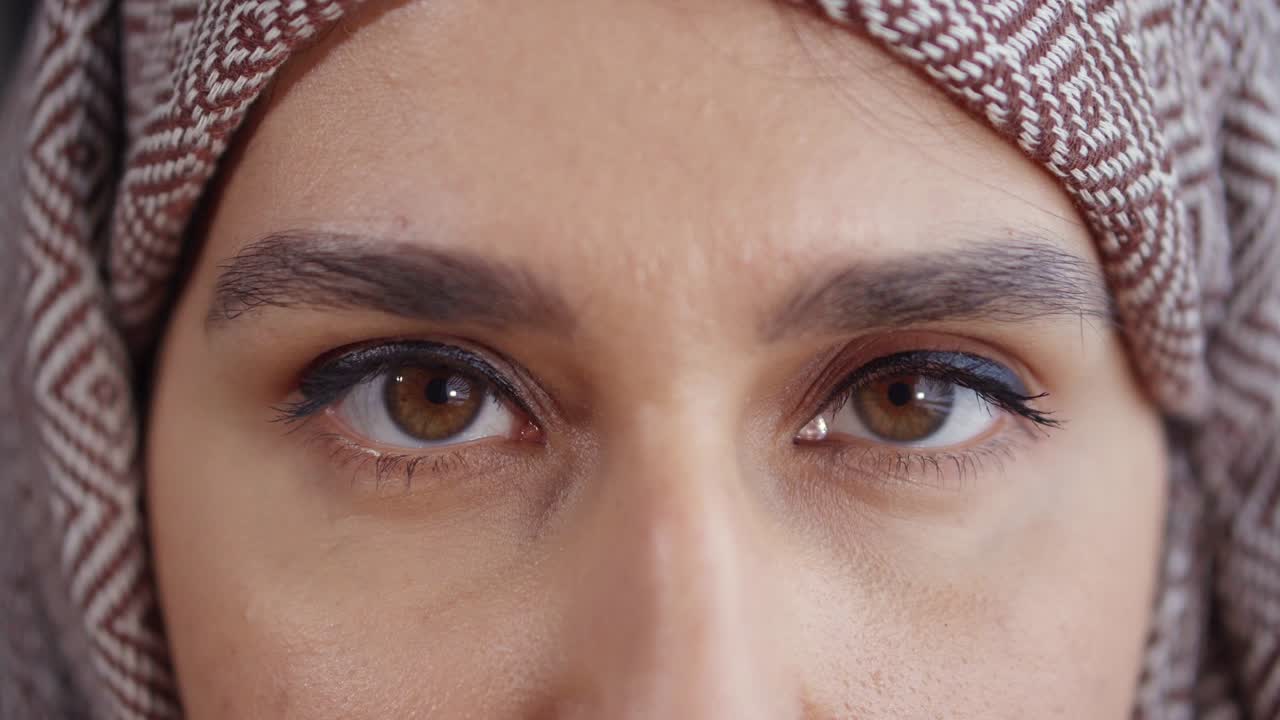 Middle-east woman with eyes closed.