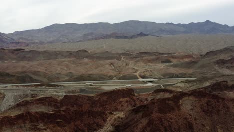 aerial view of highway 93 in middle of desert and mountains, in cloudy kingman, usa