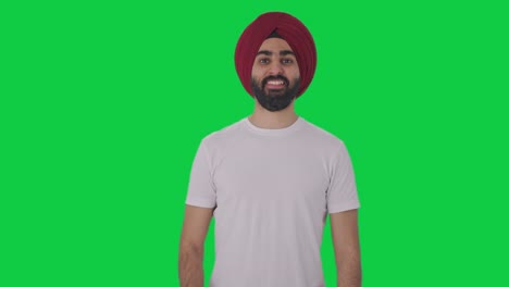 happy sikh indian man showing thumbs up green screen