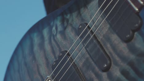 closeup of hands playing an electric guitar