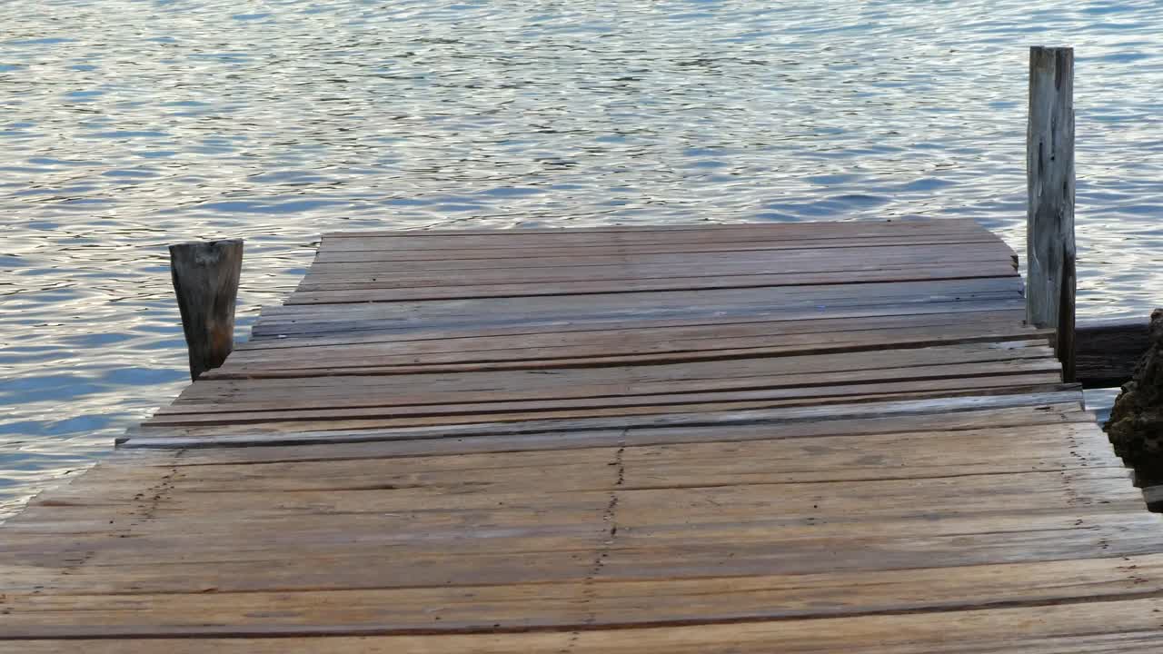 View of part of a wooden walkway with the calm sea
