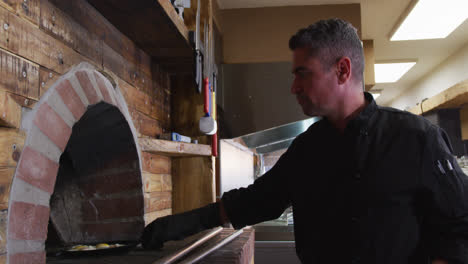 Hombre-Caucásico-Posando-Un-Plato-En-El-Horno