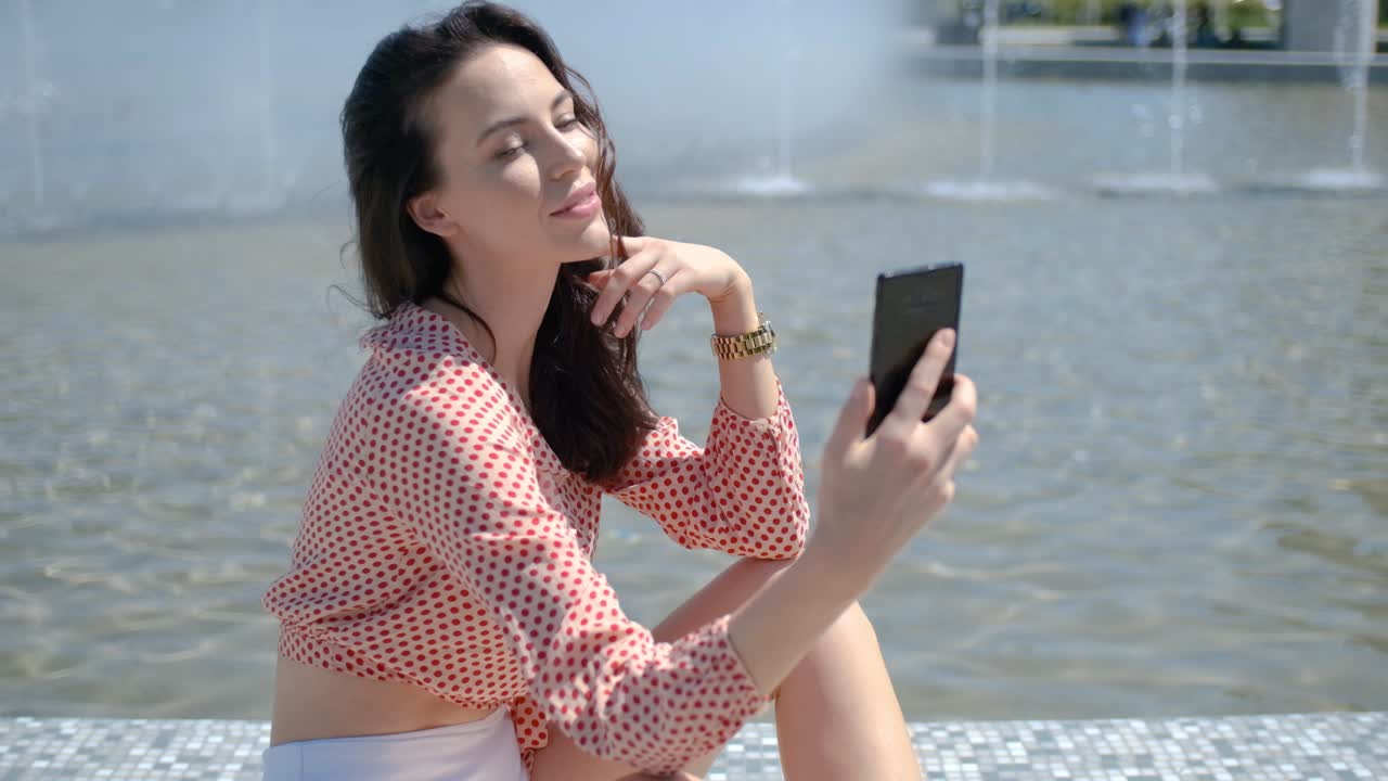 그녀의 휴대 전화로 셀카 사진을 찍는 예쁘고 섹시한 여자