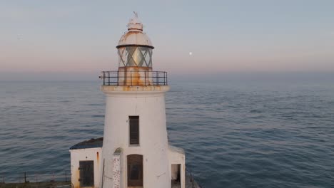 traditional white lighthouse at golden hour, in northumberland, england
