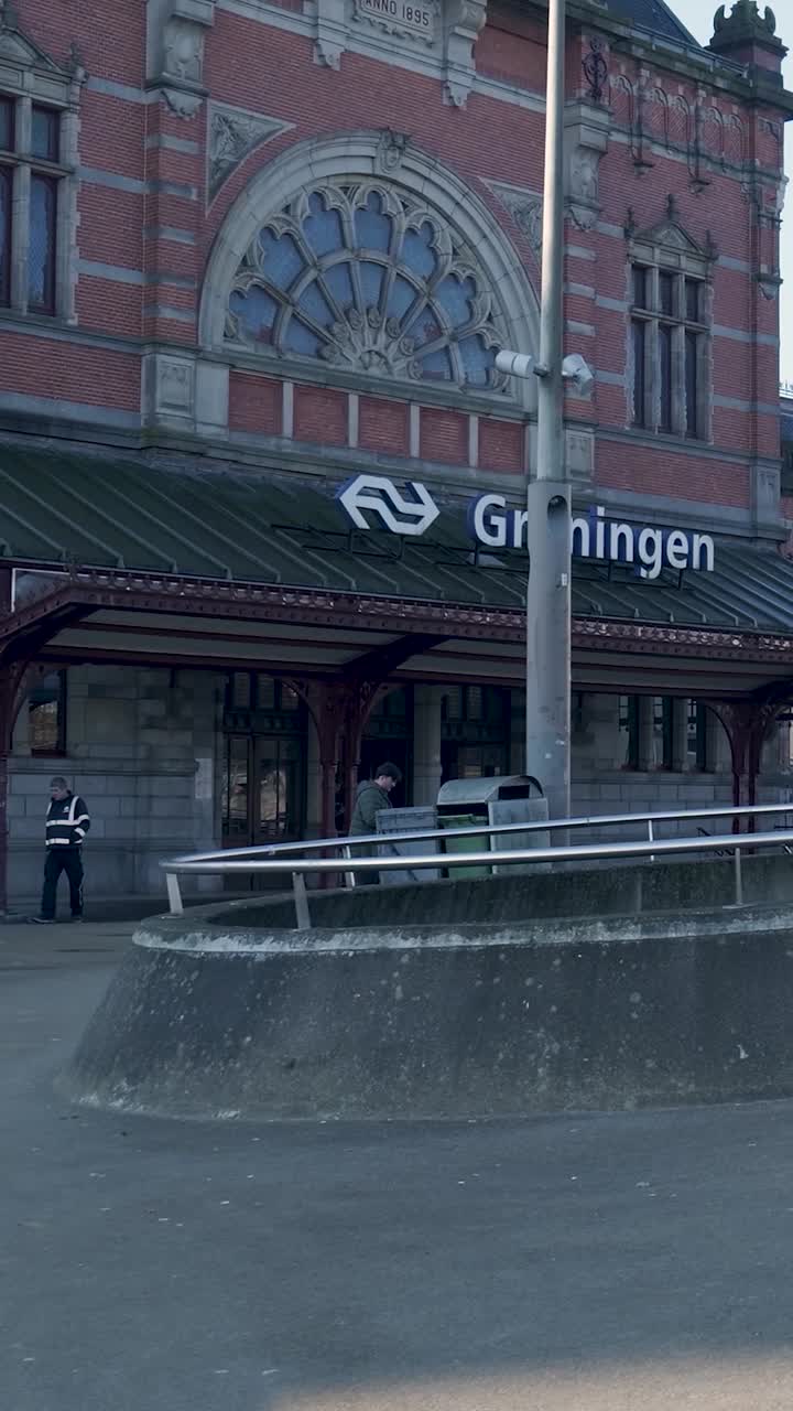 Vista esterna della stazione ferroviaria di Groningen con persone
