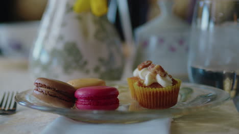 panning shot of macarons and other desserts at sophisticated tea party