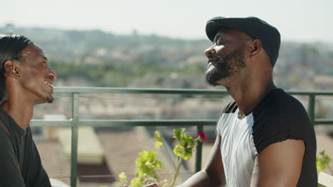 happy afro-american gay couple having date at rooftop