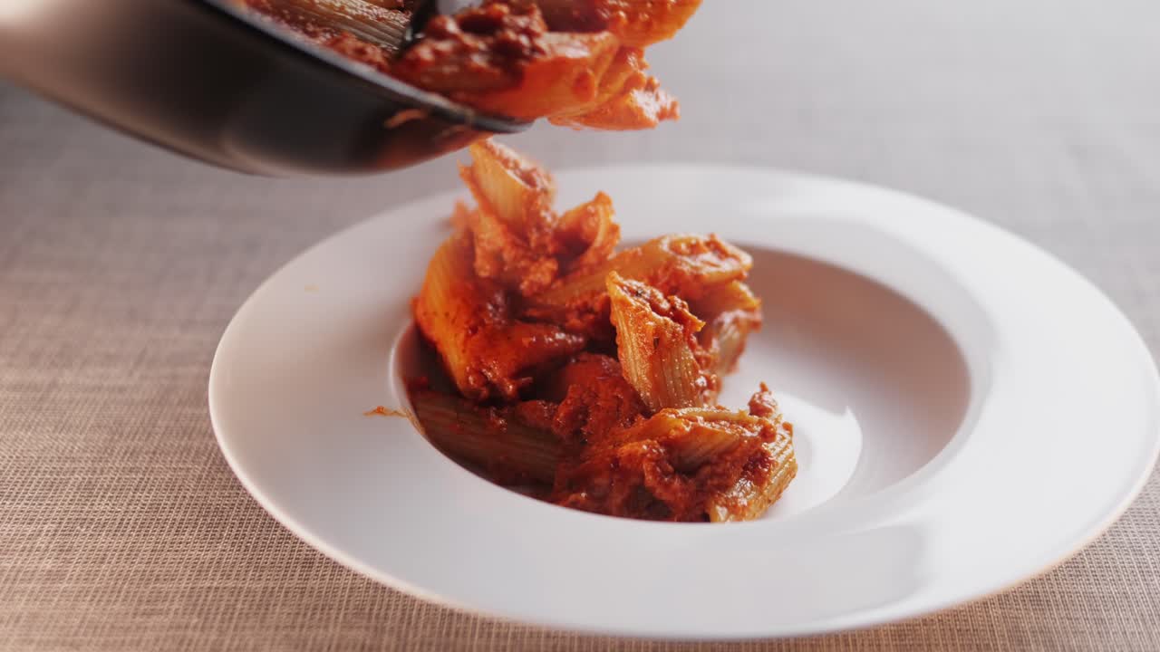 Pasta with tomato sauce being served