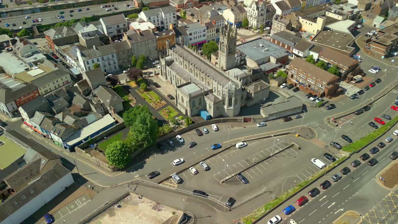 Push-out aerial of Newry Cathedral, in Newry, County Down in Northern Ireland, UK on a bright and sunny day. Filmed in 4K, 60FPS and with Rec709 color.