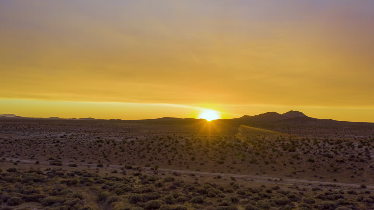 Golden dawn illuminates the sky in this epic sunrise aerial hyperlapse
