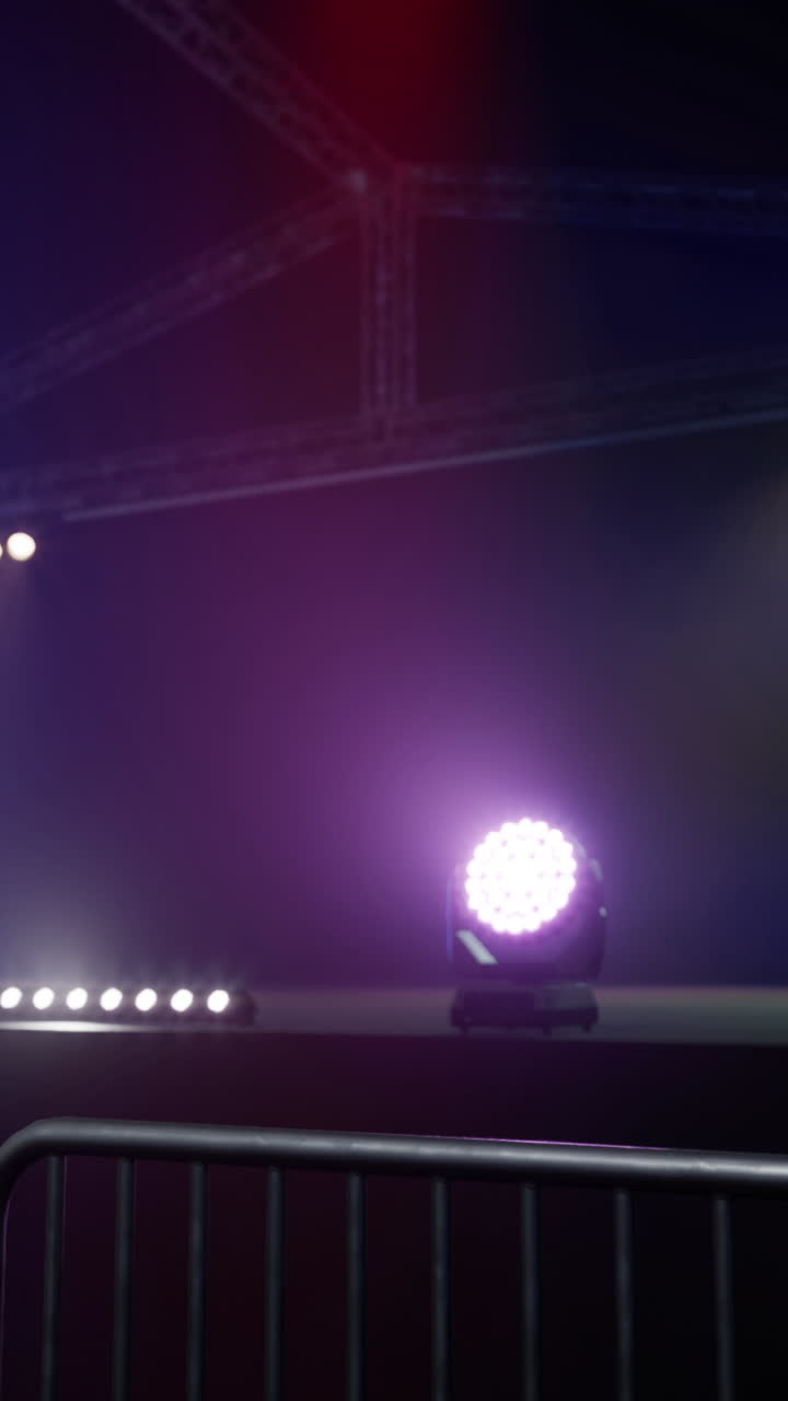 Lighting setup at an event venue featuring bright stage lights and barriers