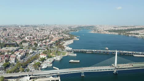 bosphorus bridges connecting europe and asia in istanbul on blue sky day, aerial drone view