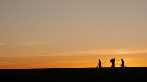 farmers working at sunset