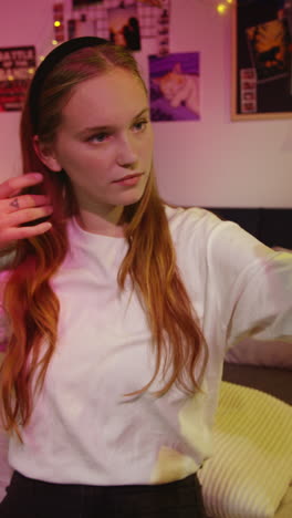 young woman taking a selfie in her bedroom