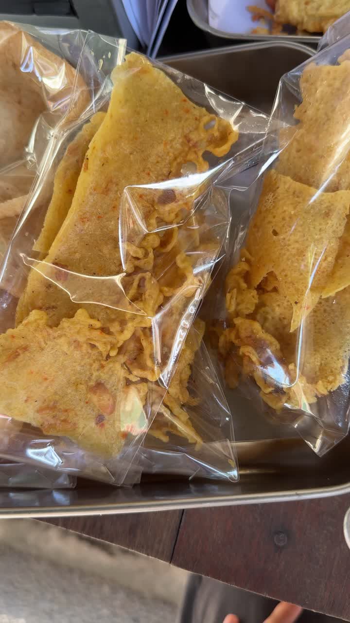 Close-Up of Various Packaged Traditional Snacks in a Metal Tray