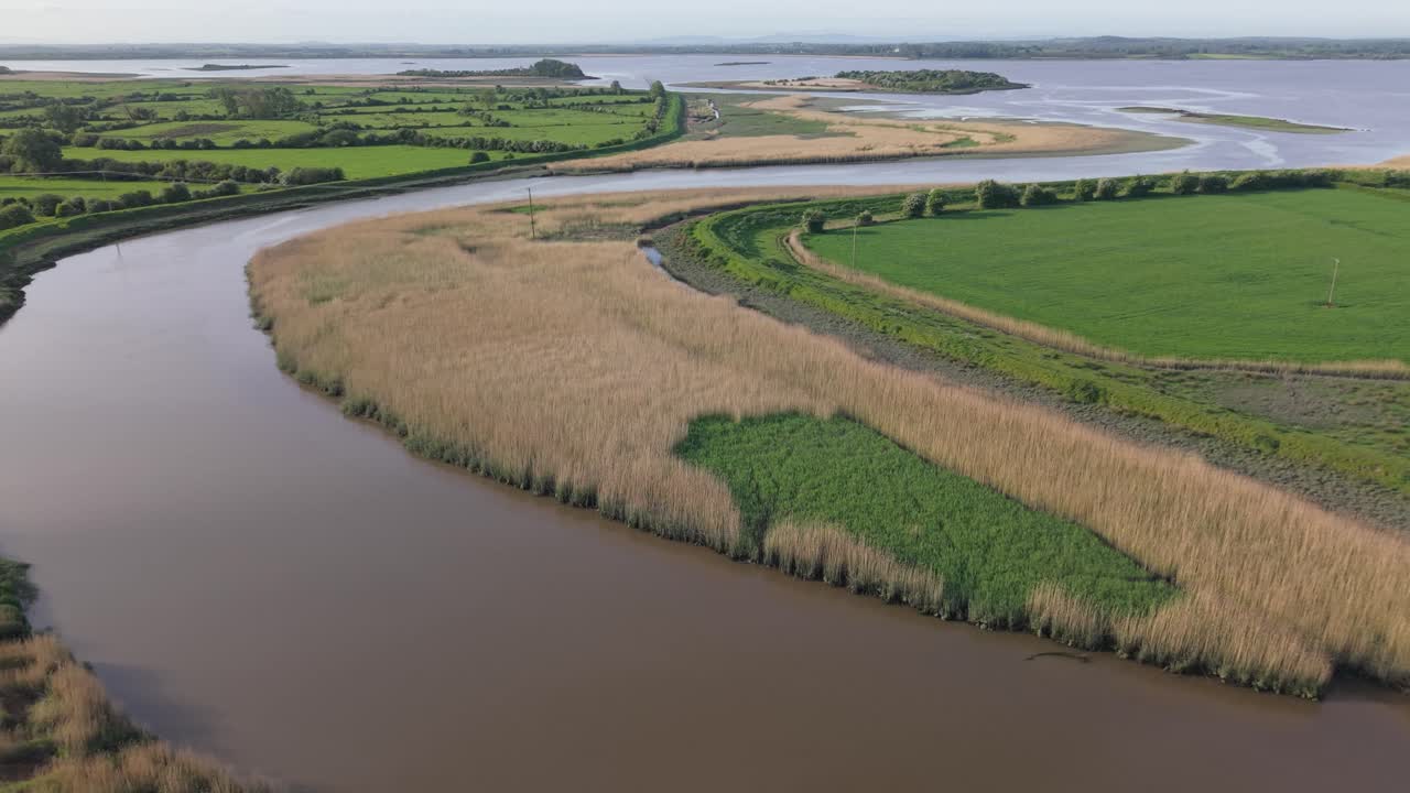 Ralty River joins the Shannon River in County Clare, Ireland, with scenic views of the green landscape and the waterways