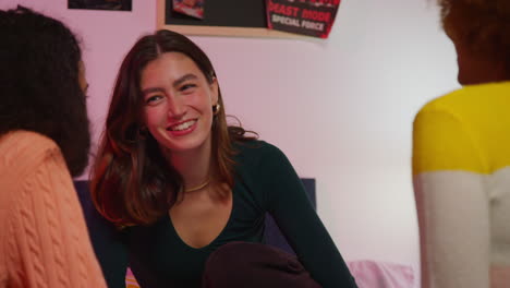 three friends enjoying conversation in a bedroom