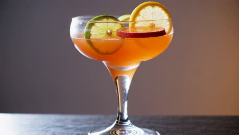 vibrant orange cocktail with citrus garnish