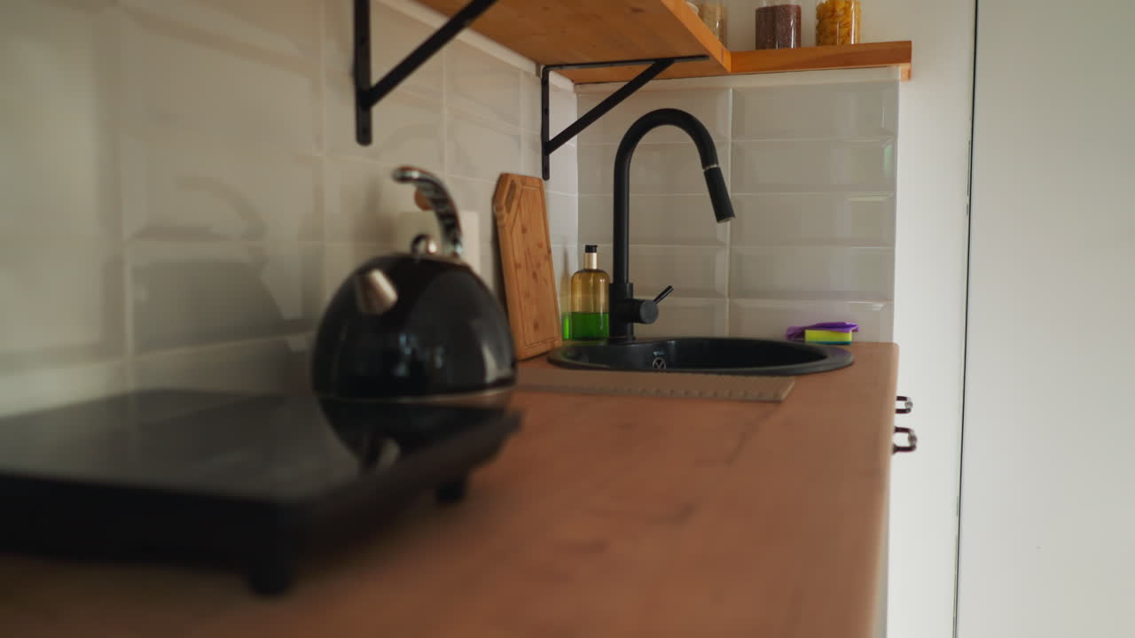 Well-equipped kitchen with cooking utensils. Bright and adorned space aims for ensuring cozy and pleasant experience for travelers seeking accommodation