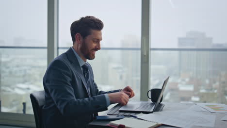 smiling boss talking video meeting at company office closeup. man holding papers