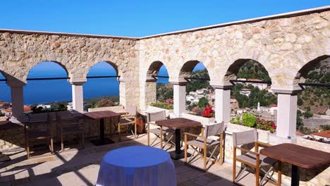 taverna with arches and stone walls offers a spectacular overlook of the serene ionian sea in albania