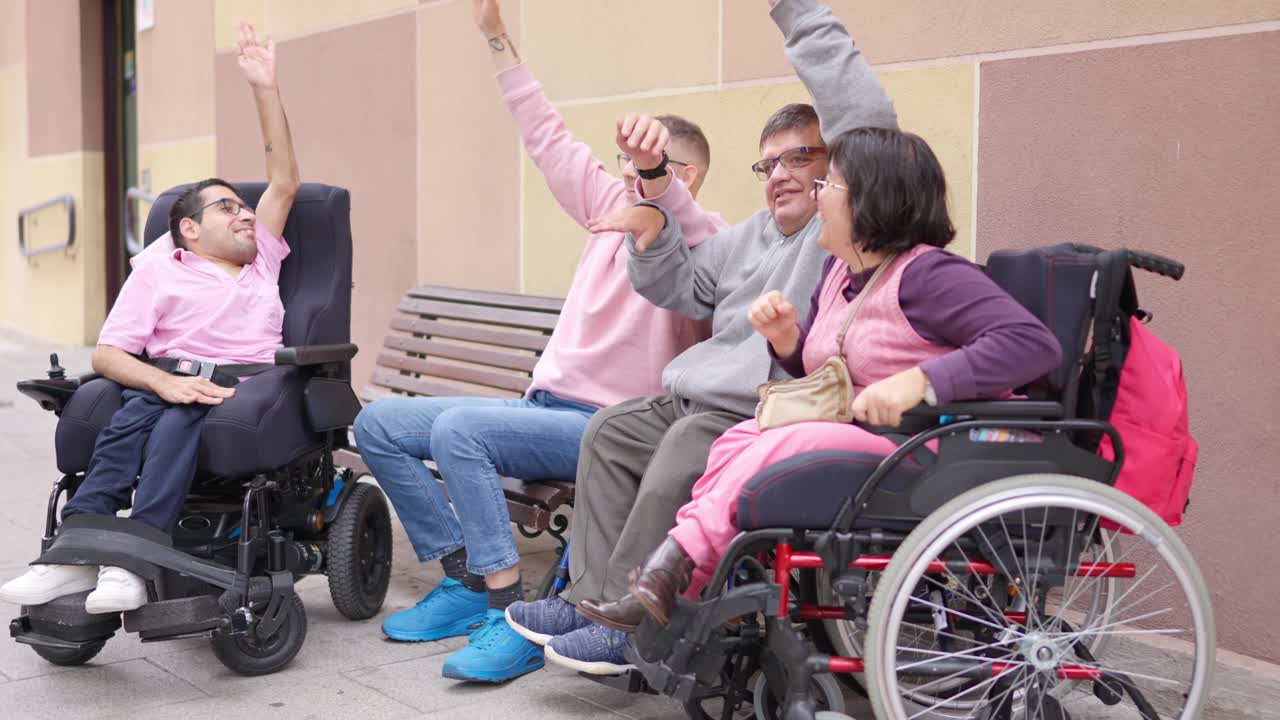 Diverse Group of Friends with Disabilities Raising Hands Outdoors