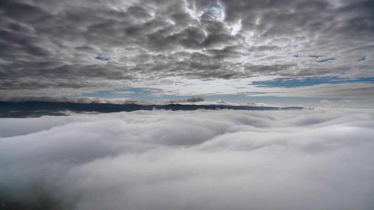 Aerial View of Thick Clouds Covering a Mountain Valley