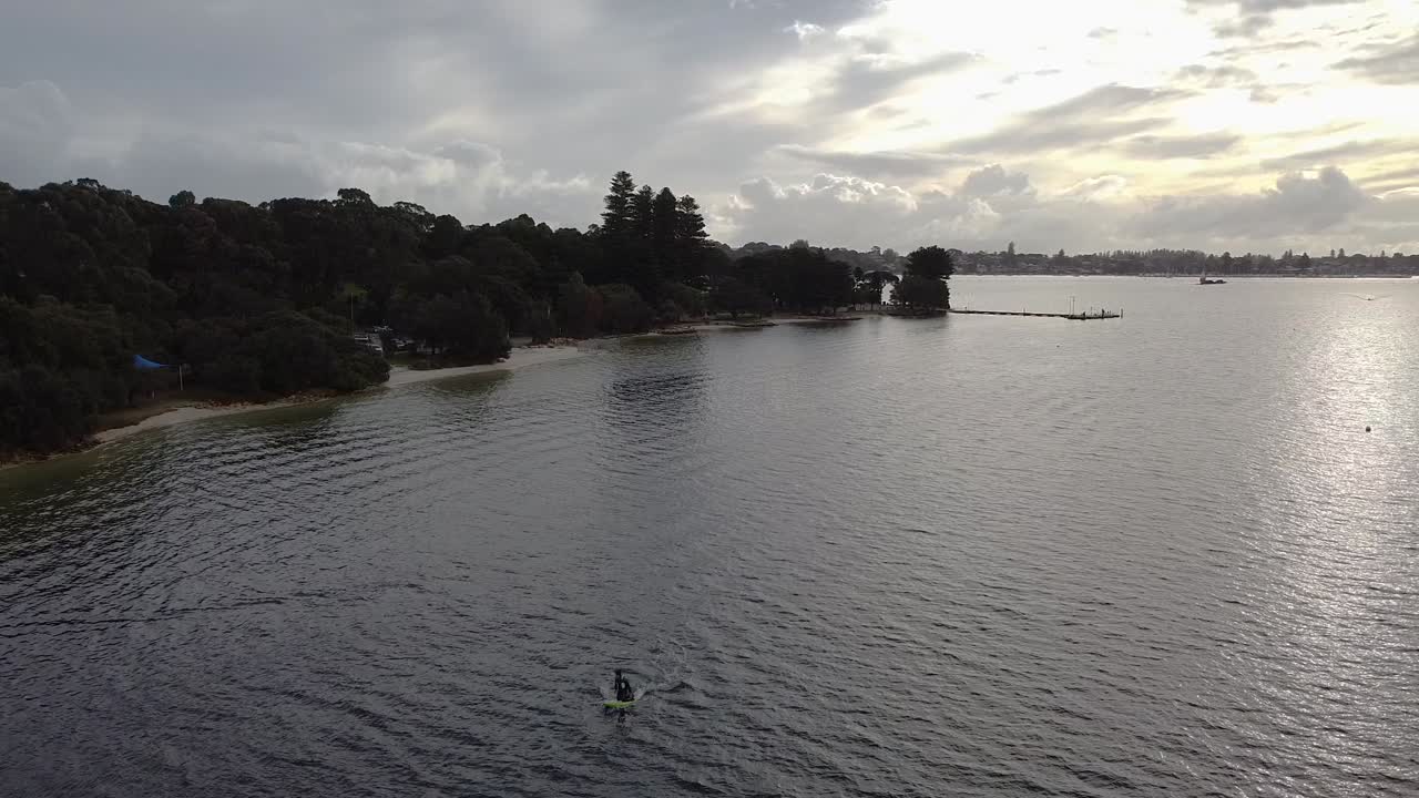 Paddleboarding on a Tranquil Bay with Sunset Light