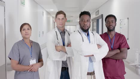 portrait of serious diverse doctors and nurses with arms crossed in slow motion, unaltered