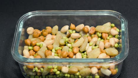 taking soak sprouts and nuts from tifinbox closeup view