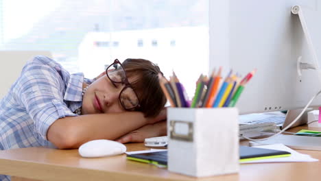 Pretty-designer-napping-on-her-desk