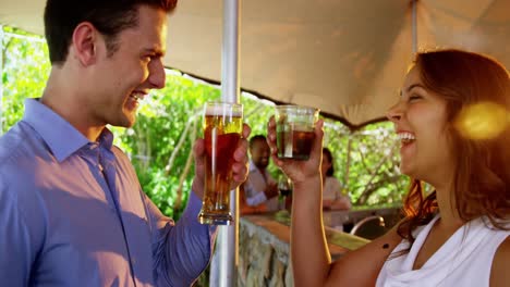 happy couple toasting glasses of drinks