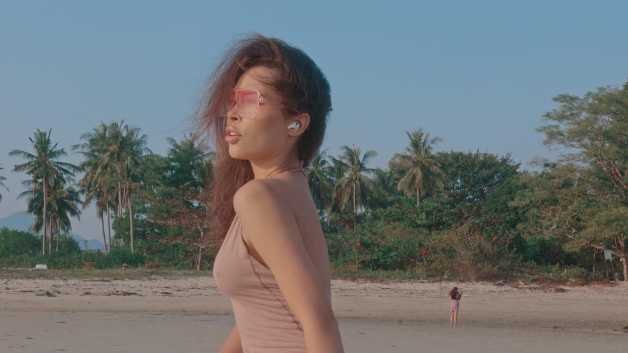 Woman enjoying a beach sunset