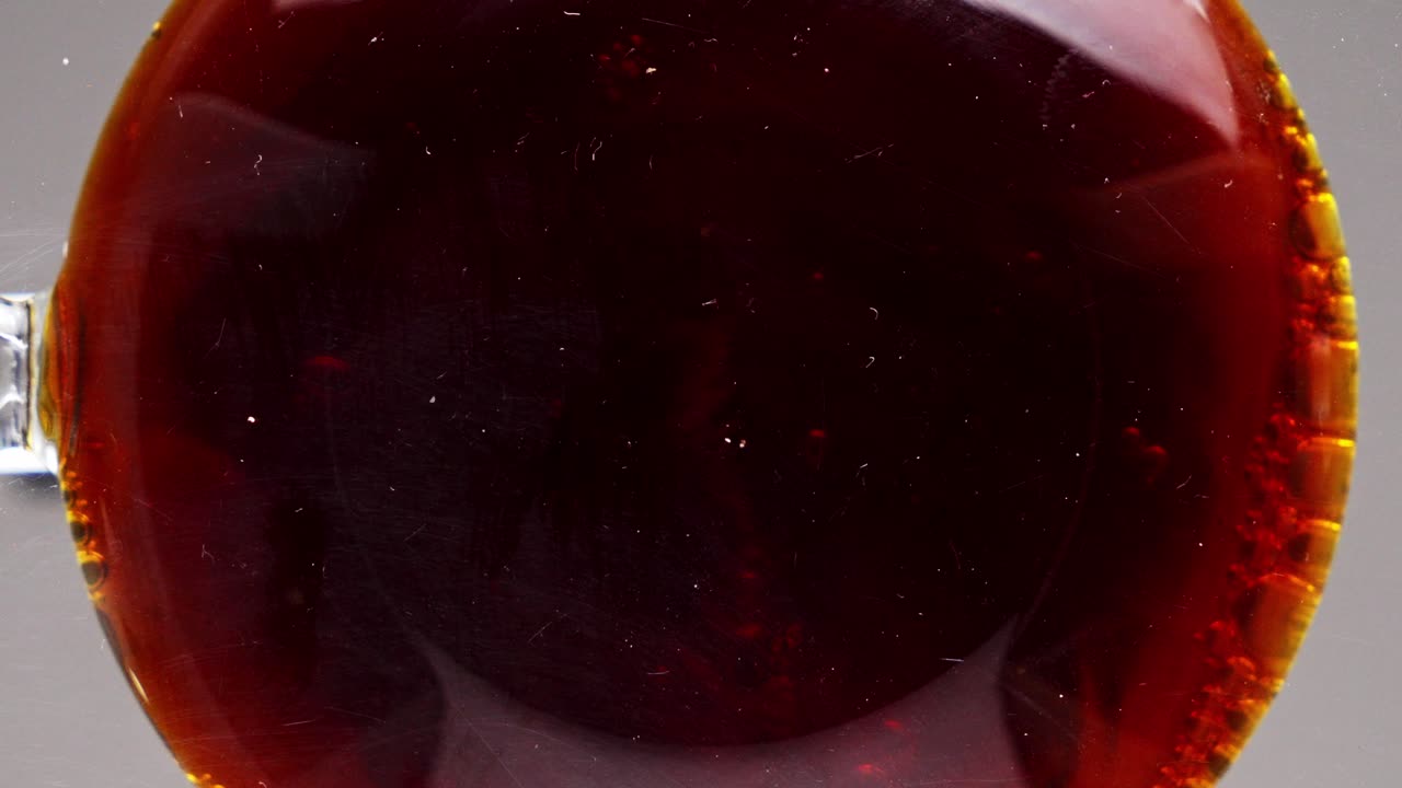 Carbonated liquid with bubbles seen from bottom perspective
